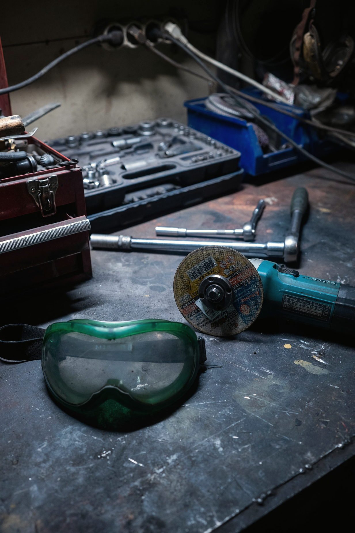 Hand tools and safety goggles laid out on a workshop bench