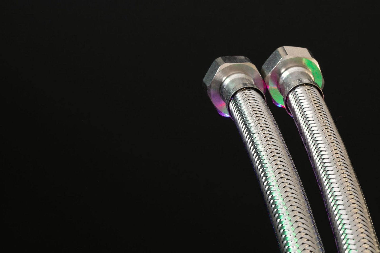 Two braided stainless hydraulic hoses with crimped hex ends