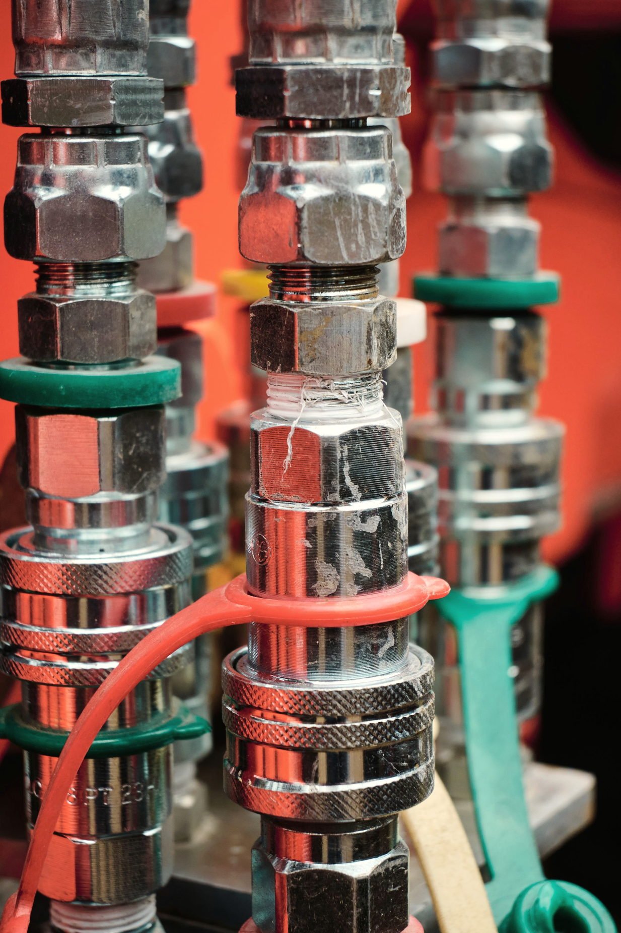 A rack of hydraulic fittings and couplers in close-up