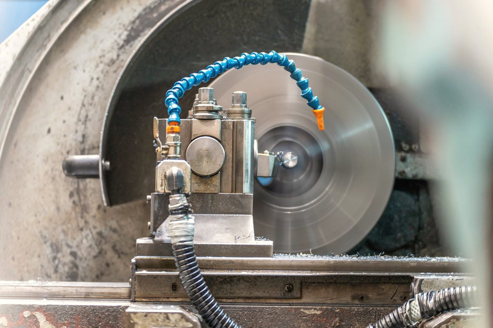 A grinding wheel with a coolant line running to the work