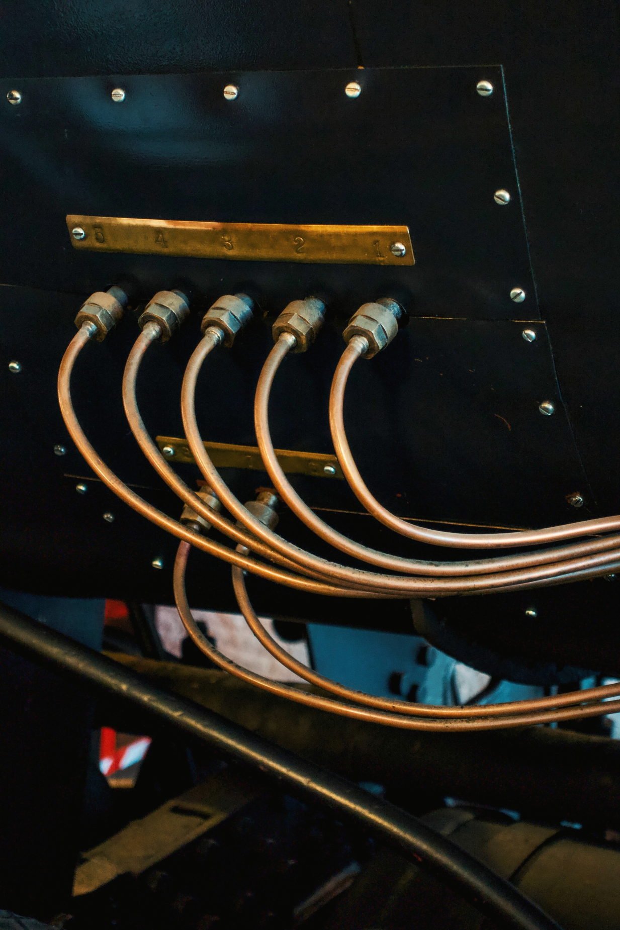 A bank of hydraulic hose runs with copper coloured tubing