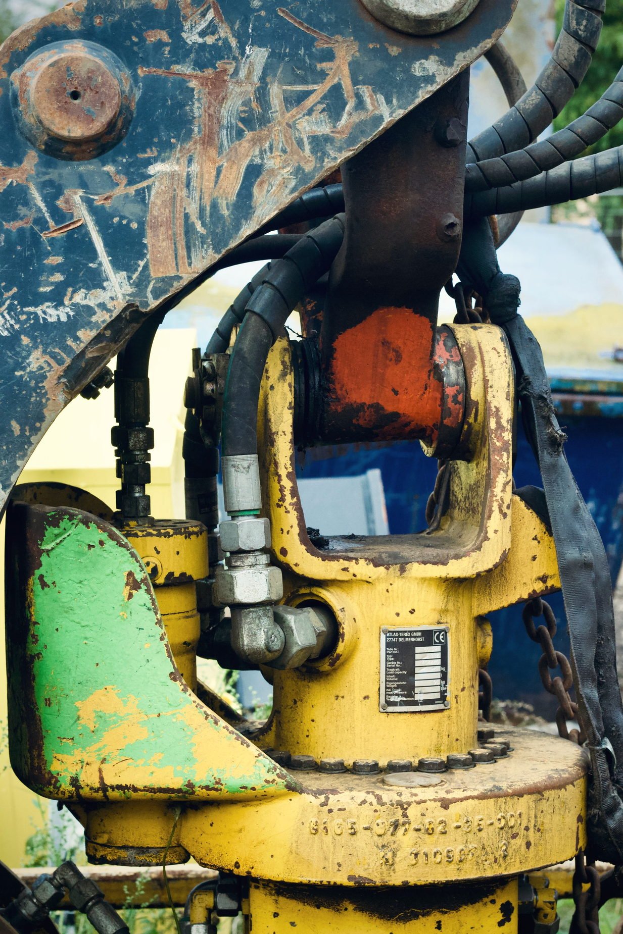 A worn hydraulic unit with chipped paint and fittings